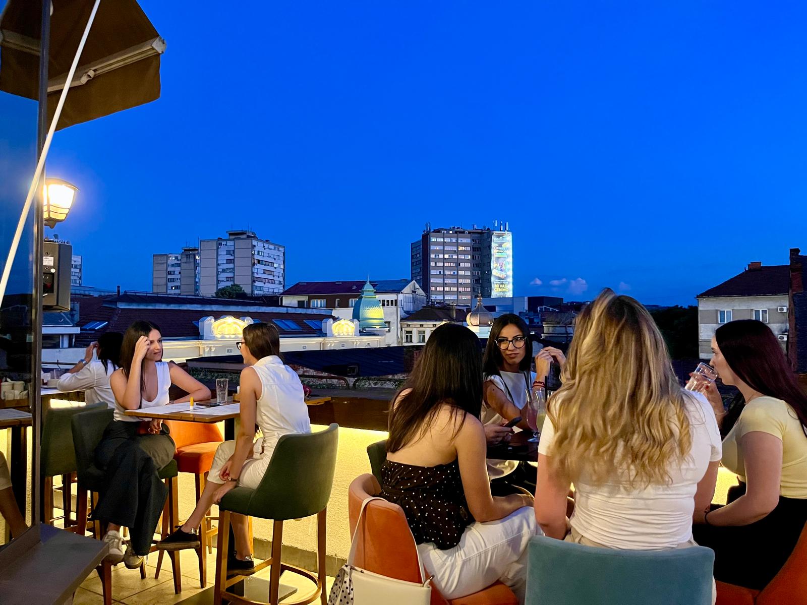 Guests enjoying the rooftop at dusk